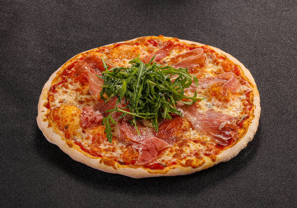 Pizza with parma, cheese and rucola