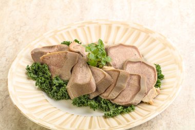 Dilimlenmiş domuz dili aperatifi. Fesleğen servis edildi.