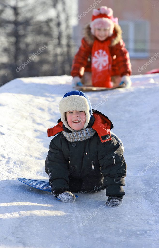 Children slide down icy hill — Stock Photo © krugloff 18676905