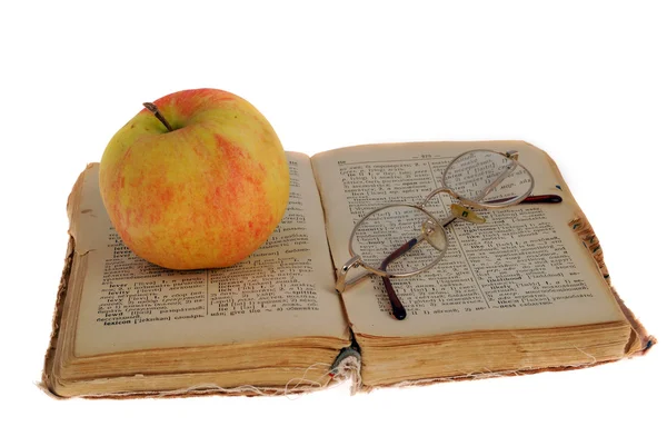 Apple and glasses on the book — Stock Photo, Image