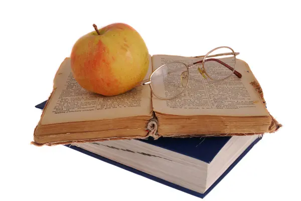 Apple and glasses on the book — Stock Photo, Image