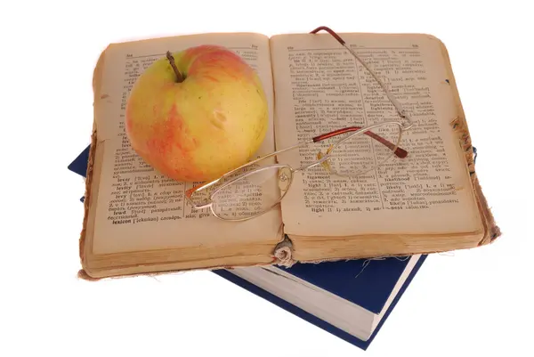 Apple and glasses on the book — Stock Photo, Image