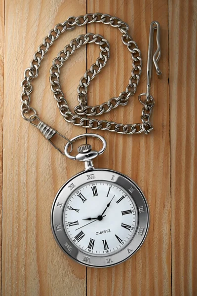 Vintage pocket watch with chain on table — Stock Photo, Image