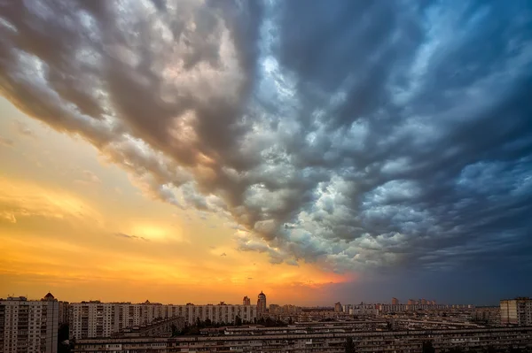 Hintergrund eines Sonnenuntergangs Gewitterwolken über der Stadt — Stockfoto