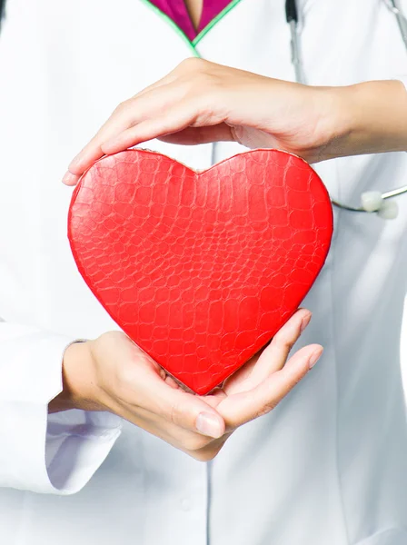 Medical doctor holding red heart — Stock Photo, Image