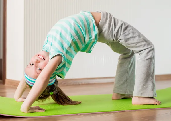 Little girl doing gymnastic exercises — Stock Image Little girl doing gymnastic exercises Stock Photo