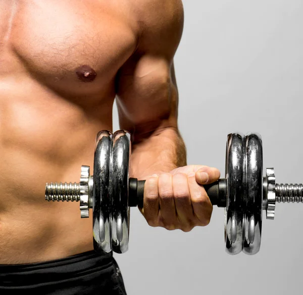 Powerful muscular man lifting weights — Stock Photo, Image