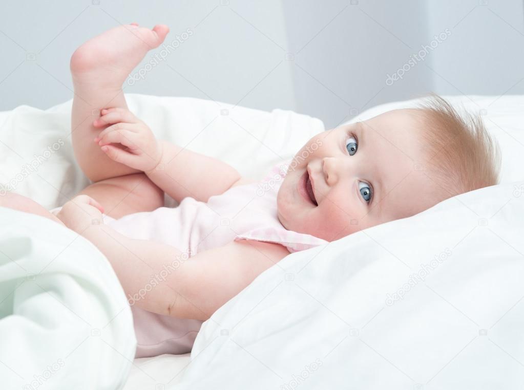 Baby playing with his feet Stock Photo by ©tan4ikk 25167281