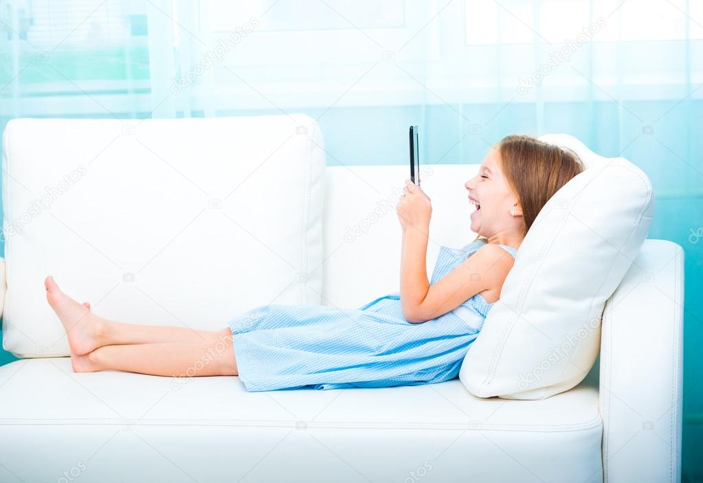 little girl holding a e-book