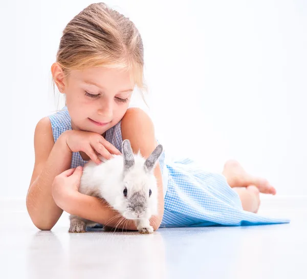 Cute smiling girl with a white rabbit — Stock Photo, Image