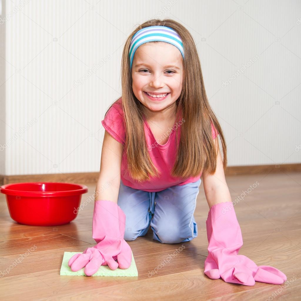 little girl cleans the house