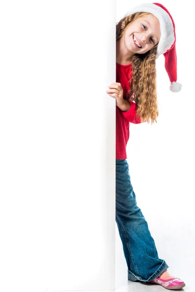 Dívka v santa hat blízko bílou tabuli — Stock fotografie