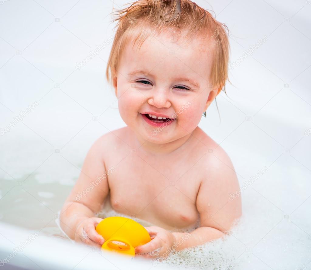 cute 1 year-old girl bathes