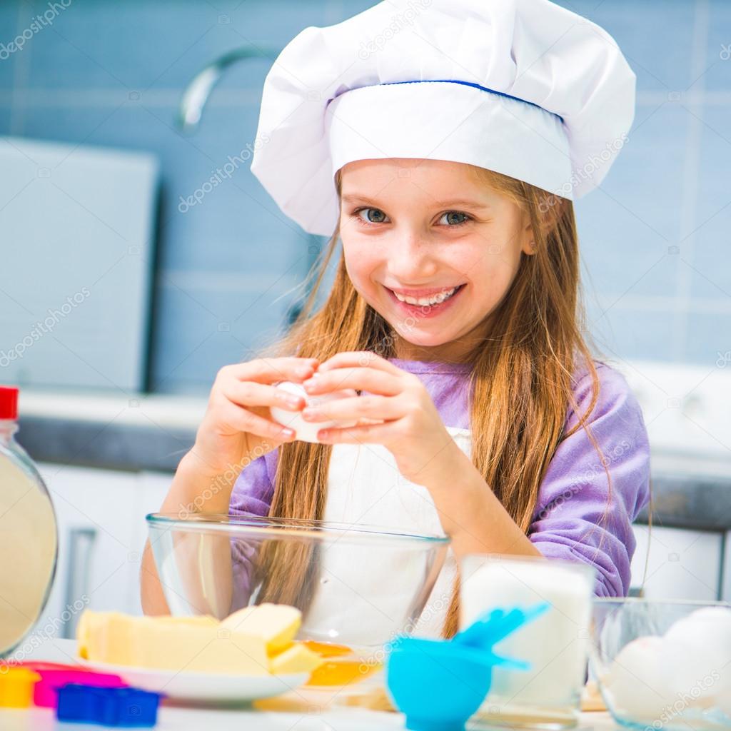 Cute little girl preparing cookies