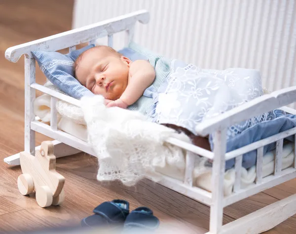 Newborn baby in a small bed — Stock Photo, Image