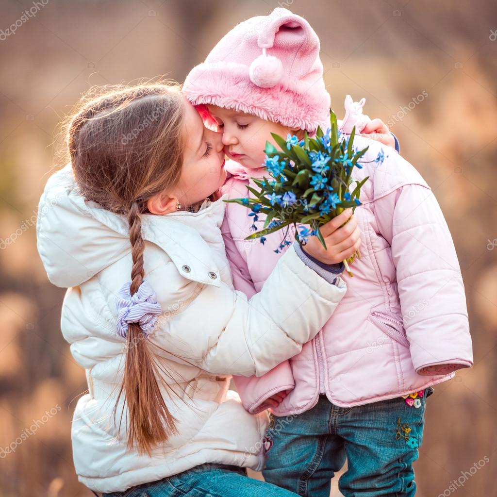 two little girls kissing 