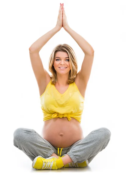 Беременная женщина в позе лотоса — стоковое фото