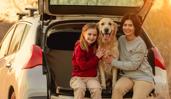 Rodzina z psem golden retriever w samochodzie — Zdjęcie stockowe