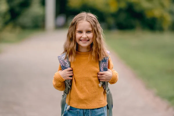 Schoolgirl with backpack outdoors — Stock Photo, Image