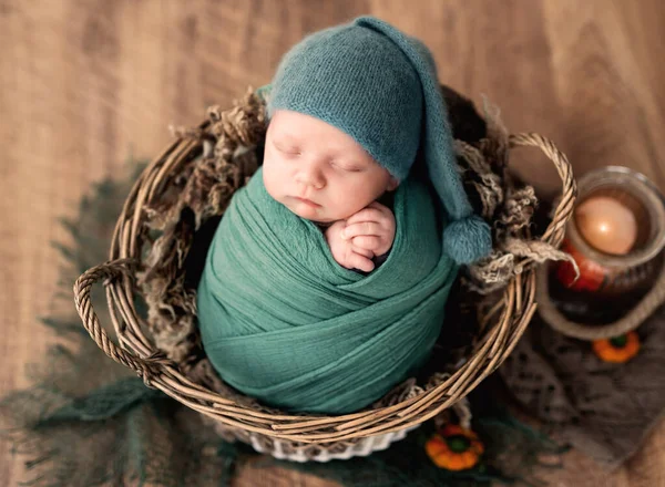 Peacefully sleeping newborn in basket with blue blanket Stock Photo by  ©tan4ikk 112241718