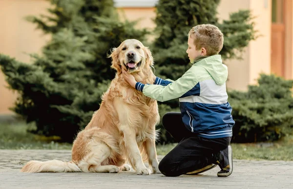 Peuter jongen met golden retriever hond — Stockfoto