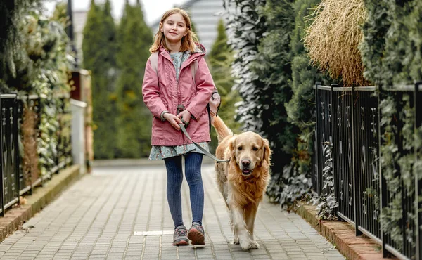 Flicka och golden retriever hund — Stockfoto