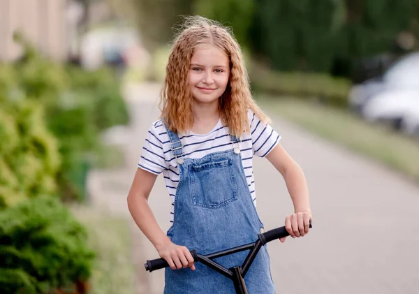 Little Girl Riding Kick Scooter Street Home — Zdjęcie stockowe