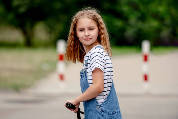 Little Girl Riding Kick Scooter Street Home — Zdjęcie stockowe