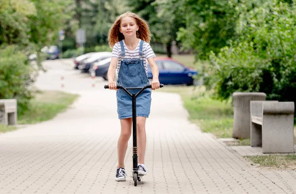 Little Girl Riding Kick Scooter Street Home — стоковое фото