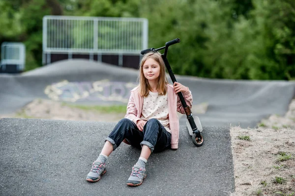 Preteen Girl Scooter Sitting City Park Spring Time Looking Camera — Stockfoto