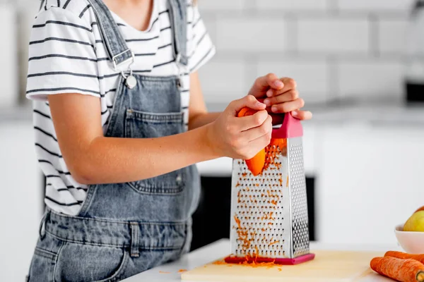 Girl Child Hands Grinds Carrot Using Grater Kitchen Closeup Pretty — Stock fotografie