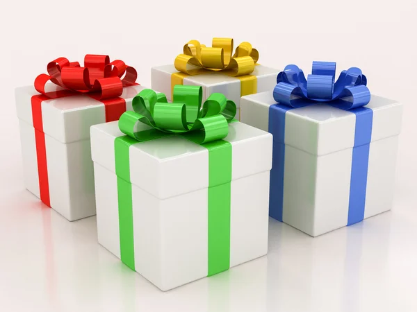 White gift boxes with varicolored ribbon — Stock Photo, Image