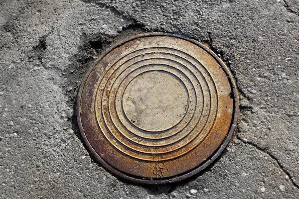 Rusty round manhole Stock Photo