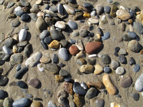 Zand achtergrond met zee steentjes — Stockfoto