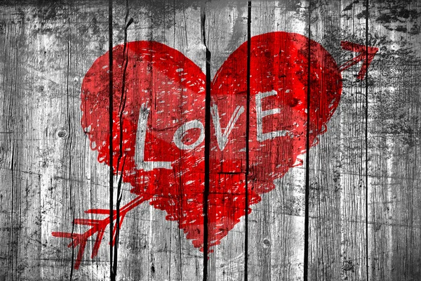 Drawing of a heart with word "Love" on grunge wooden wall — Stock Photo, Image