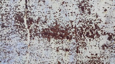 Eski metal paslı duvarın dokusu zaman ve hava durumundan dolayı çatlamış.