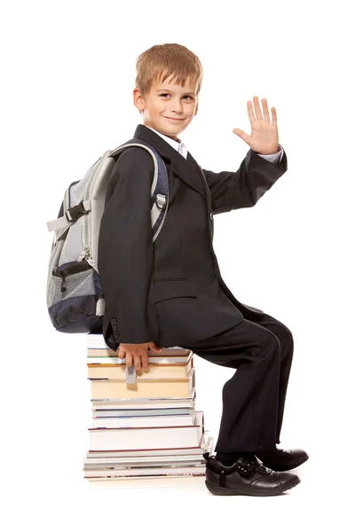 Schoolboy sitting on books. Back to school — Stock Photo, Image