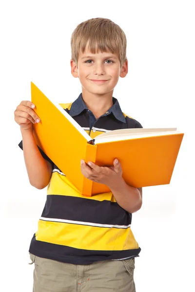 Menino da escola está segurando um livro — Fotografia de Stock