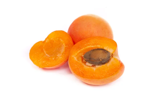 Apricots. Group of ripe apricots with a half sectioned by knife — Stock Photo, Image