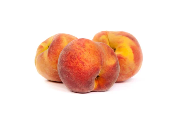 Three tasty juicy peaches on a white background — Stock Photo, Image