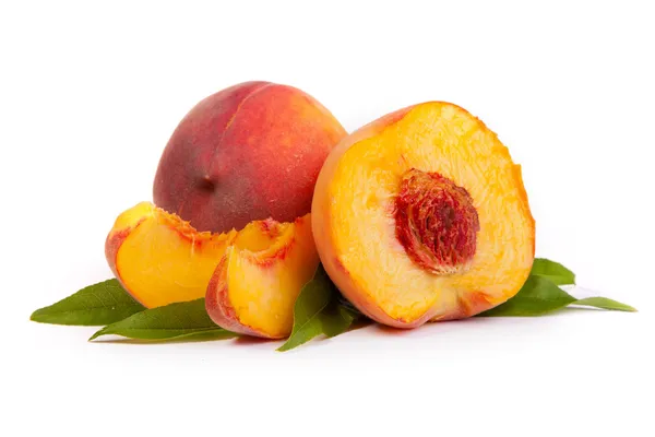 Two tasty juicy peaches with a half and slices on a white backg — Stock Photo, Image