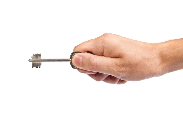 Manliga handen håller en nyckel till huset — Stockfoto