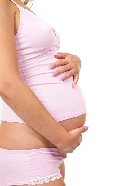 Pregnant woman is caressing her belly — Stock Photo, Image