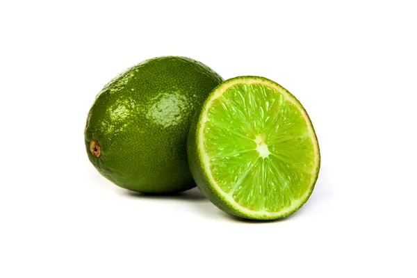 One whole lime and one half lime on white — Stock Photo, Image