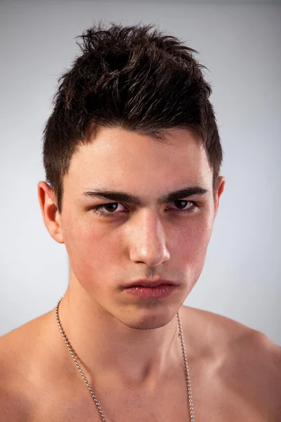 Handsome face of a young man on grey — Stock Photo, Image