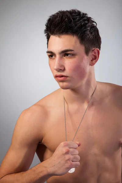 Muscular built man with a dog tags. — Stock Photo, Image