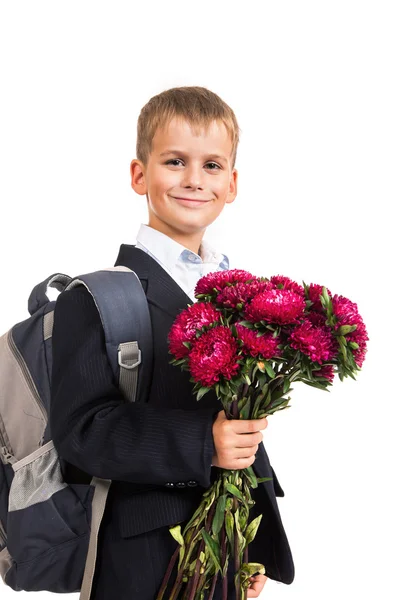 Skolpojke håller blommor. tillbaka till skolan — Stockfoto
