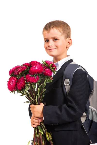 Skolpojke håller blommor. tillbaka till skolan — Stockfoto