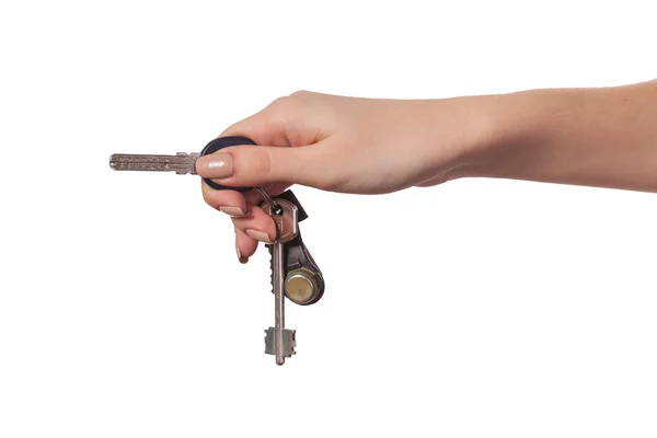 Main féminine tenant une clé de la maison — Photo