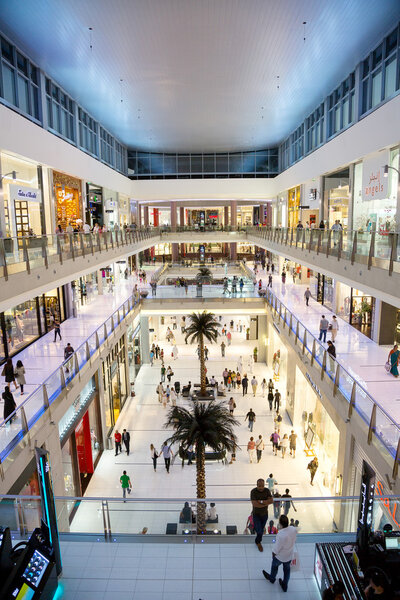 DUBAI, UAE - NOVEMBER 14: Shoppers at Dubai Mall on Nov 15, 2012 in Dubai. At over 12 million sq ft, it is the world's largest shopping mall based on total area and 6th largest by gross leasable area.